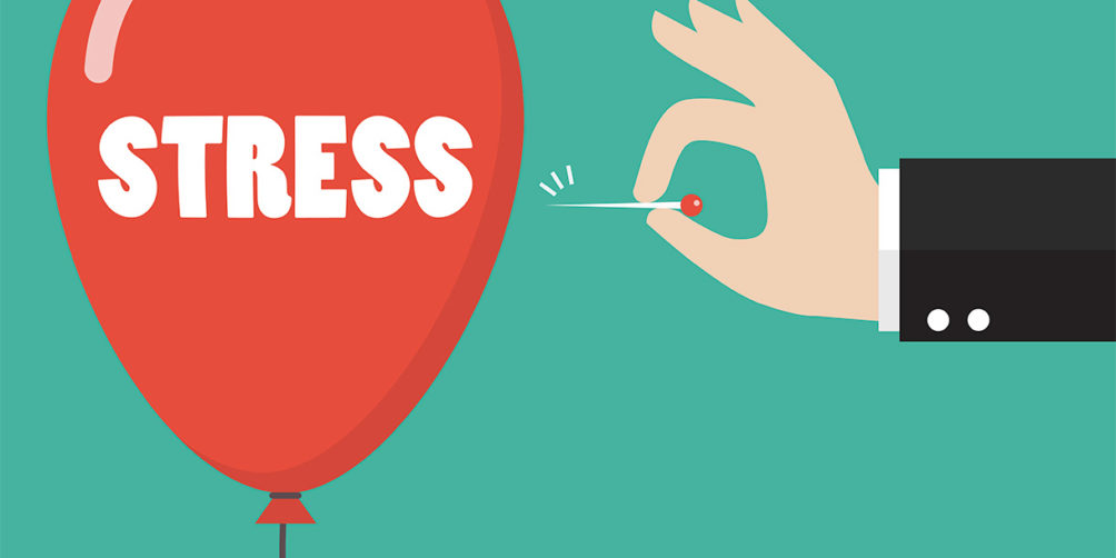 A red ballon being popped with stress written on it