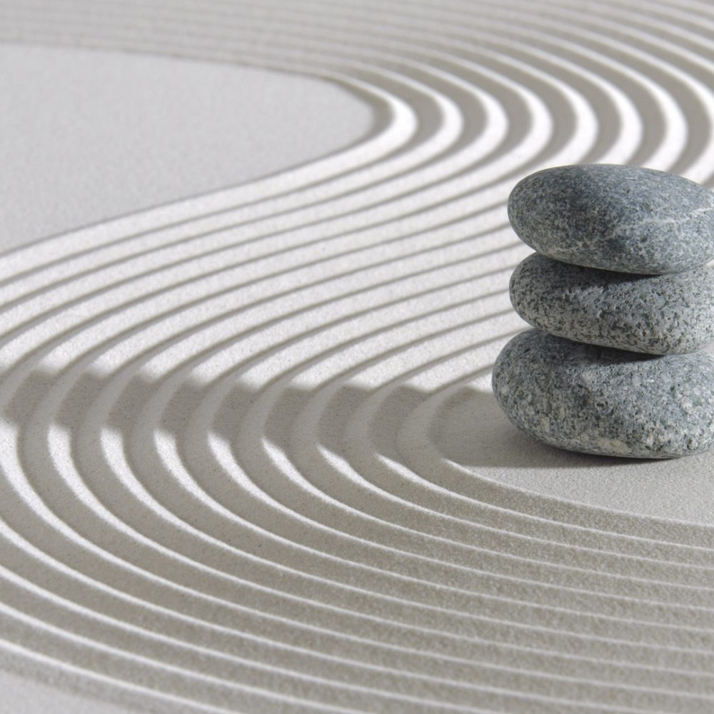 three stones stacked on sand
