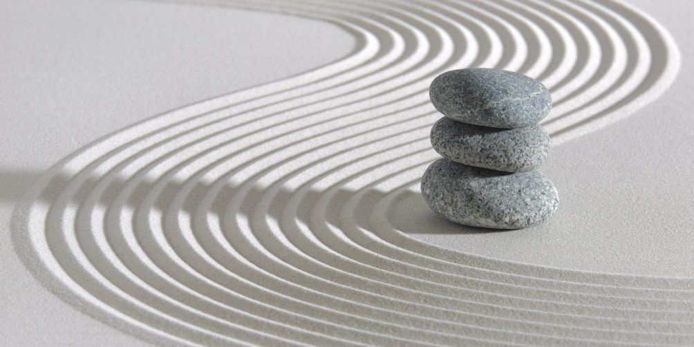 three stones stacked on sand